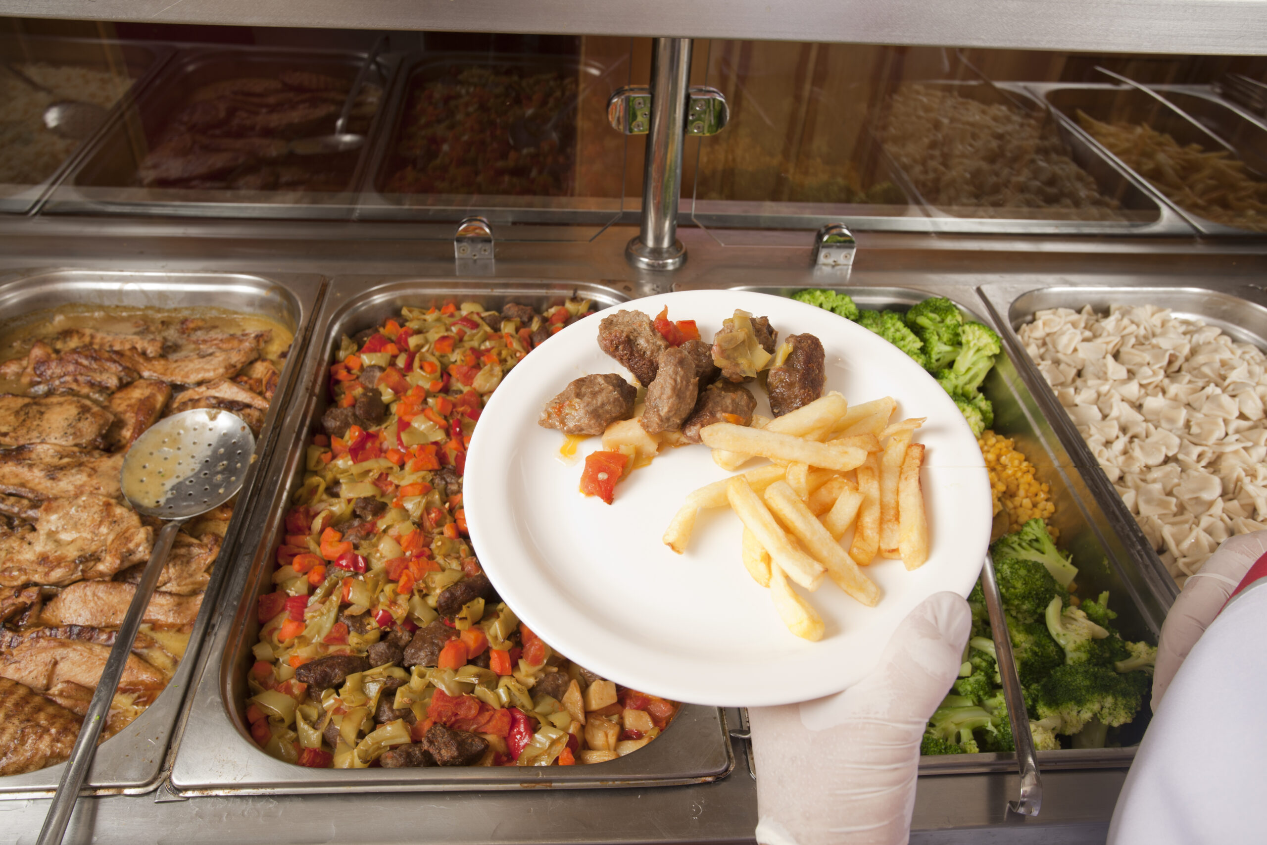 chef standing behind full lunch service station